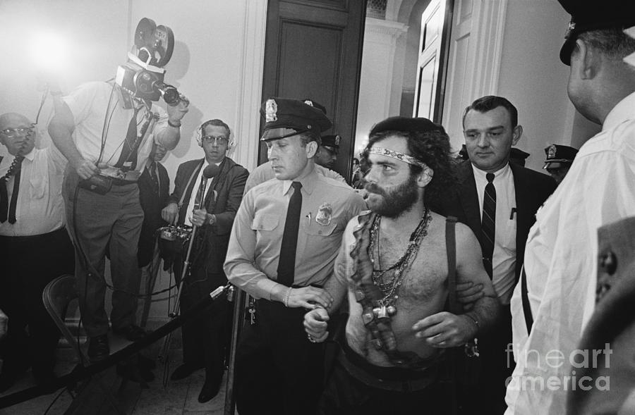 Police Escort Barechested Jerry Rubin Photograph by Bettmann