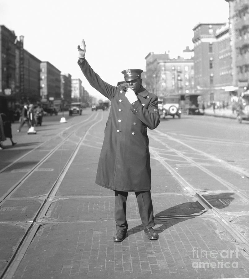 Police Raising His Arm To Direct Traffic Photograph by Bettmann