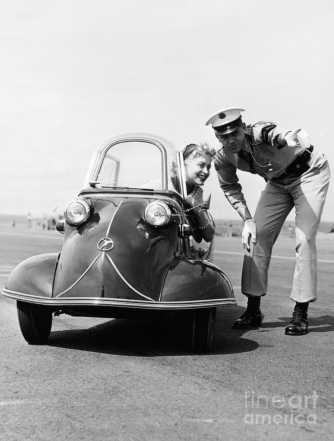 Policeman Directing Young Woman Photograph by Bettmann