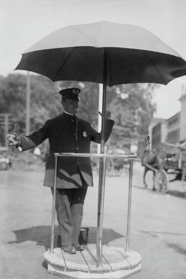 Policeman Directs traffic from underneath an umbrella in Newport, Rhode Island Painting by Unknown