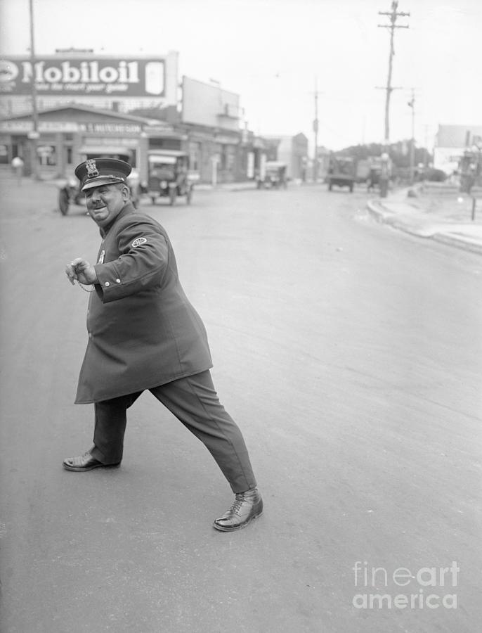 Policeman In Directing Pose Photograph by Bettmann