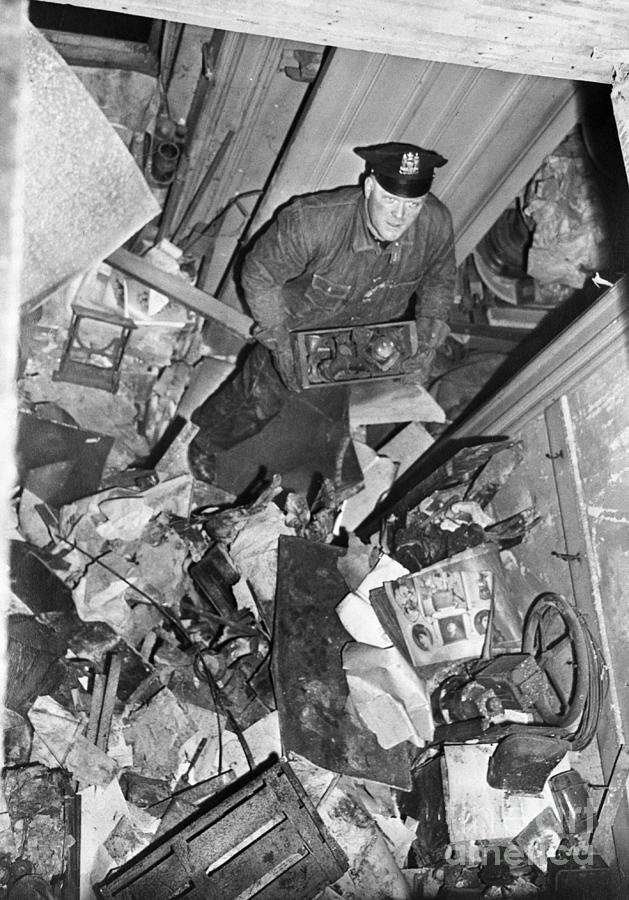 Policeman Searching Through Debris Photograph by Bettmann