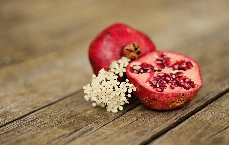 Pomegranate And Flowers On Tabletop Photograph by Anna Hwatz Photography Find Me On Facebook
