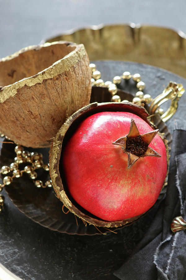 Pomegranate Arranged In Gold-painted Coconut Shell Photograph by Regina Hippel