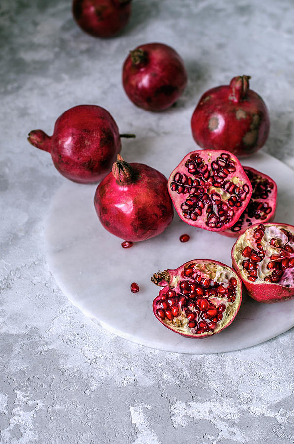 Pomegranate Fruits Whole And Sliced ??with Ripe Grains Photograph by Gorobina