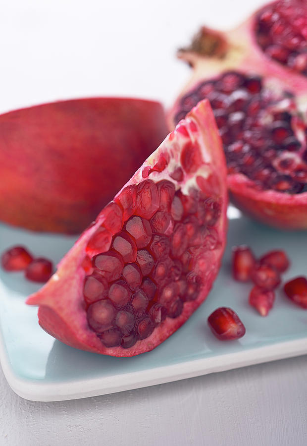 Pomegranate, Halved And Sliced close-up Photograph by Jrg Strehlau