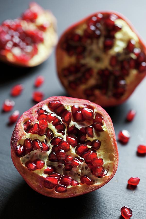 Pomegranate Segments On A Slate Surface Photograph by Jane Saunders