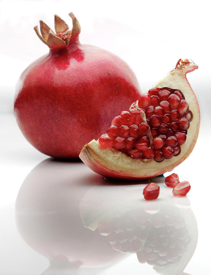 Pomegranate, With Slice, On White Photograph by Howard Bjornson