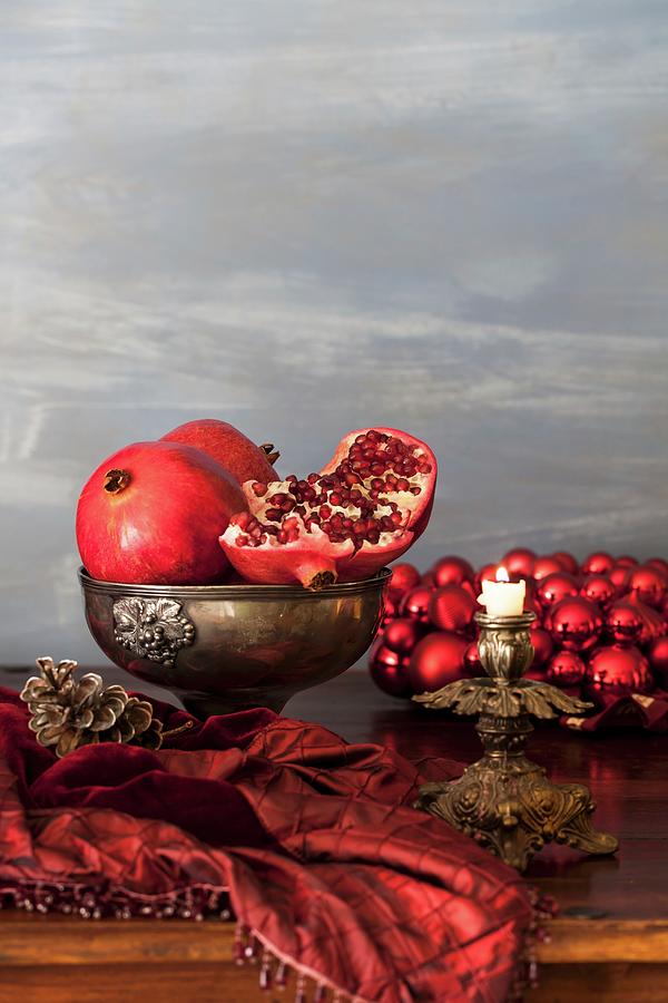 Pomegranates On A Christmas Table Photograph by Yelena Strokin