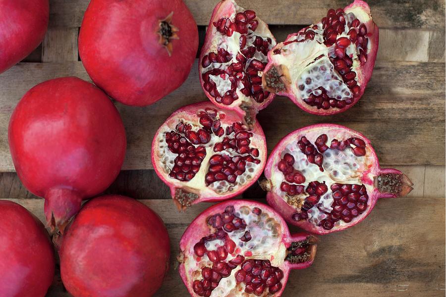 Pomegranates, Whole And Sliced seen From Above Photograph by Lisa Barber