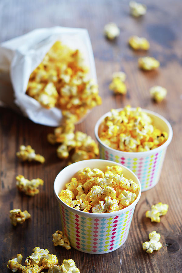 Popcorn With Curry And Salt In Paper Cups And A Paper Bag Photograph by Mariola Streim