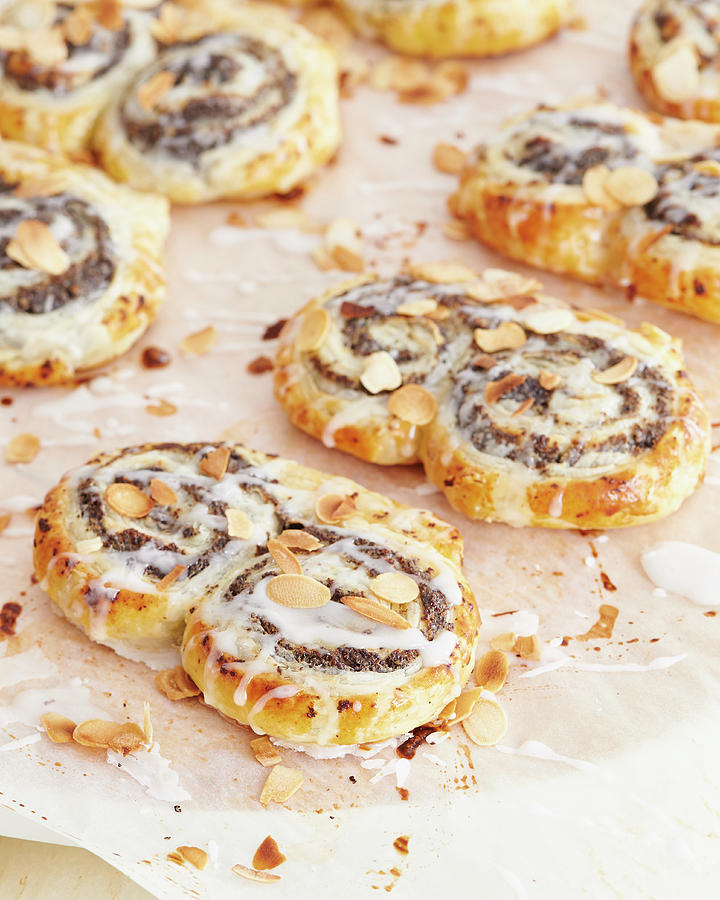 Poppy Seed Puff Pastry Buns With Icing And Flaked Almonds Photograph by Hannah Kompanik