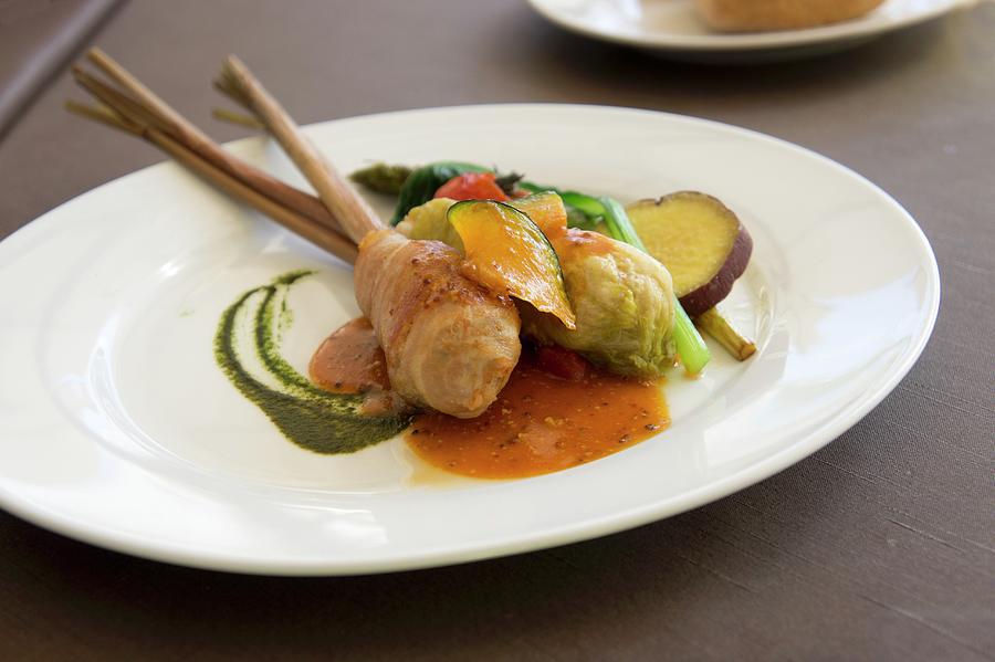 Pork Belly And Mashed Potato Roll With A Cabbage Leaf Wrap On A Stick Of Lemongrass Served With Pumpkin, Asparagus, Spinach And Sweet Potatoes Photograph by Martina Schindler