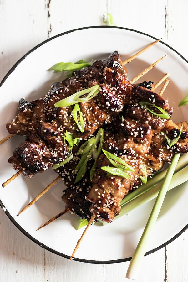 Pork Belly Skewers With Sesame Seeds And Spring Onions Photograph by ...