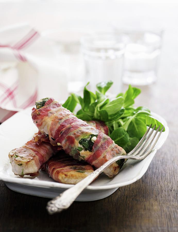 Pork Chops Wrapped In Bacon With Lambs Lettuce Photograph by Mikkel Adsbl
