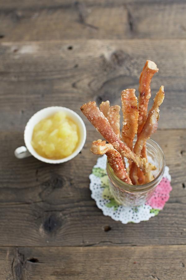 Pork Crackling Sticks As A Snack With An Apple Dip Photograph by Anne Faber