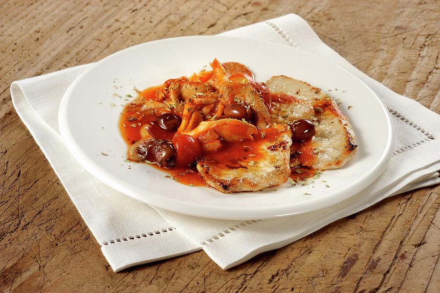 Pork Escalopes With Olive And Tomato Sauce Photograph by Franco Pizzochero