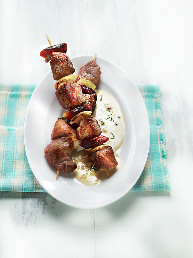 Pork, Onion And Chorizo Skewer With Munster Cheese Sauce Photograph by Perrin