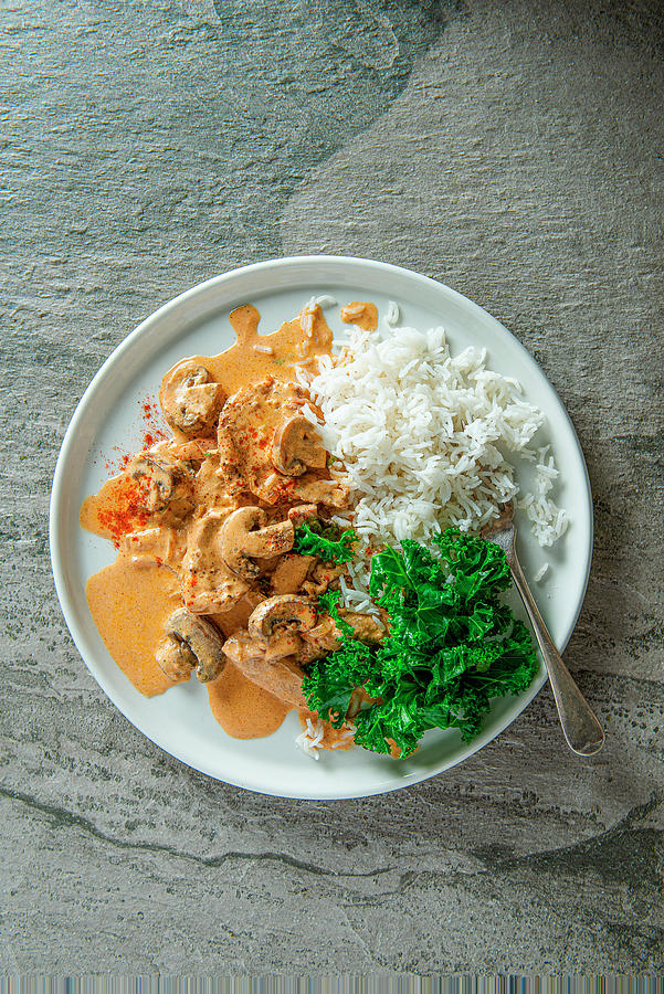 Pork Stroganoff With Mushroom, Paprika And Sour Cream, Rice And Kale On A Side, View From Above. Photograph by Magdalena Hendey