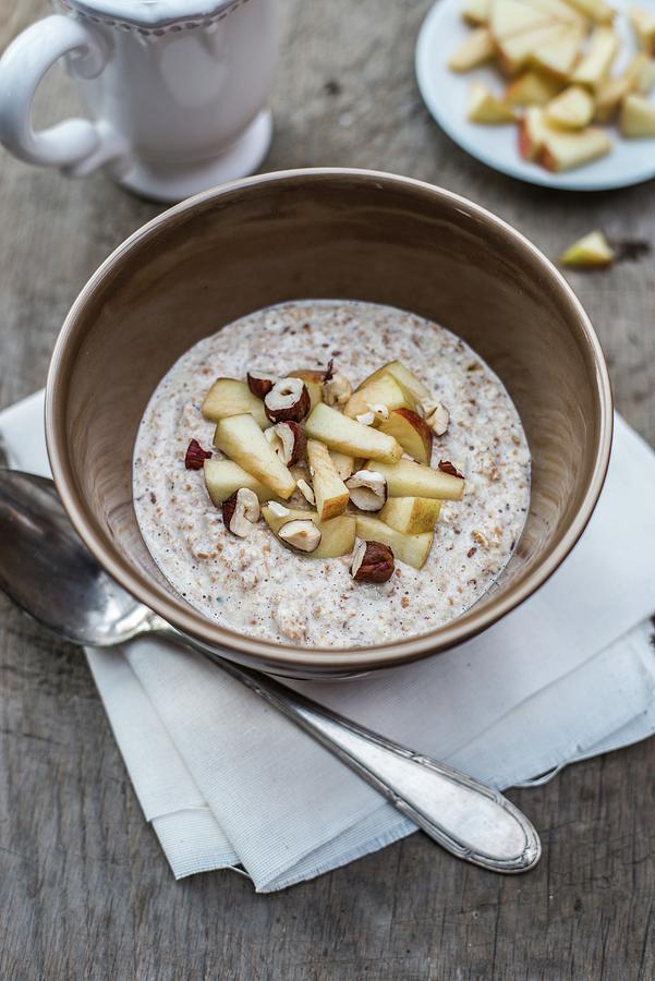 Porridge With Apple And Hazelnuts Photograph by Leah Bethmann