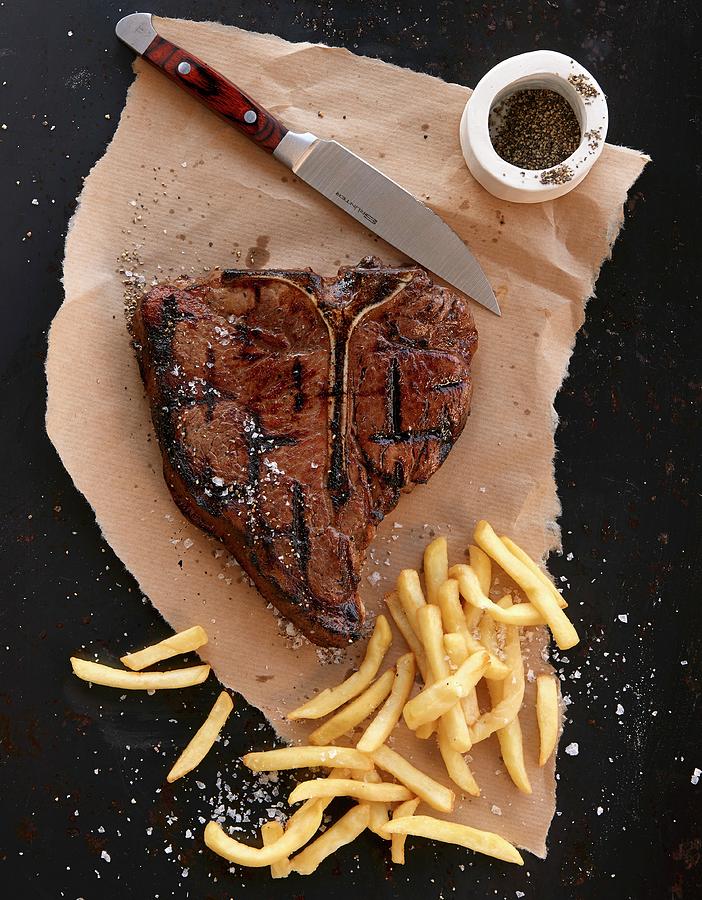 Porterhouse Steak With Fries Photograph by Robbert Koene