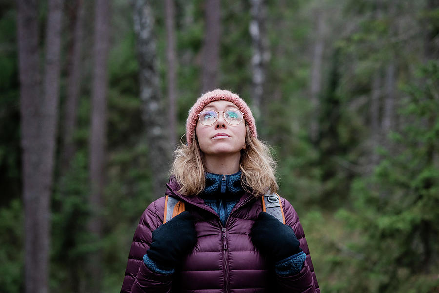 Portrait Of A Woman Looking Up At The Sky In A Forest In Winter 