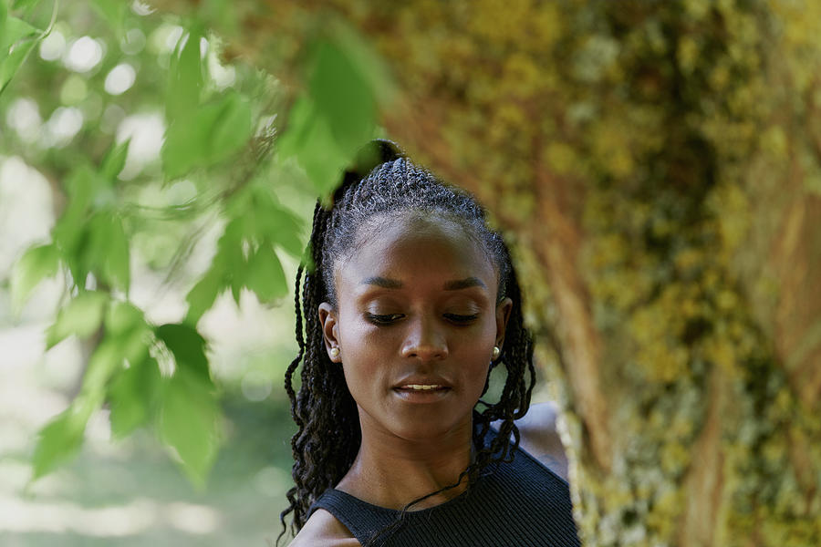 Portrait Of Beautiful Black Woman Behind A Tree Photograph by Cavan Images