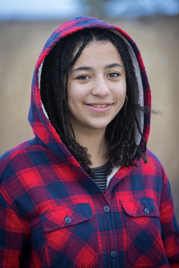 Portrait Of Biracial Young Woman Smiling With Braids And Hood ...