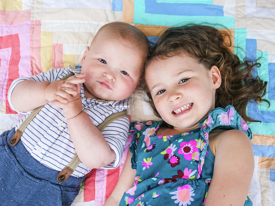 Flower Photograph - Portrait Of Brother And Sister Laying Down While Smiling by Cavan Images