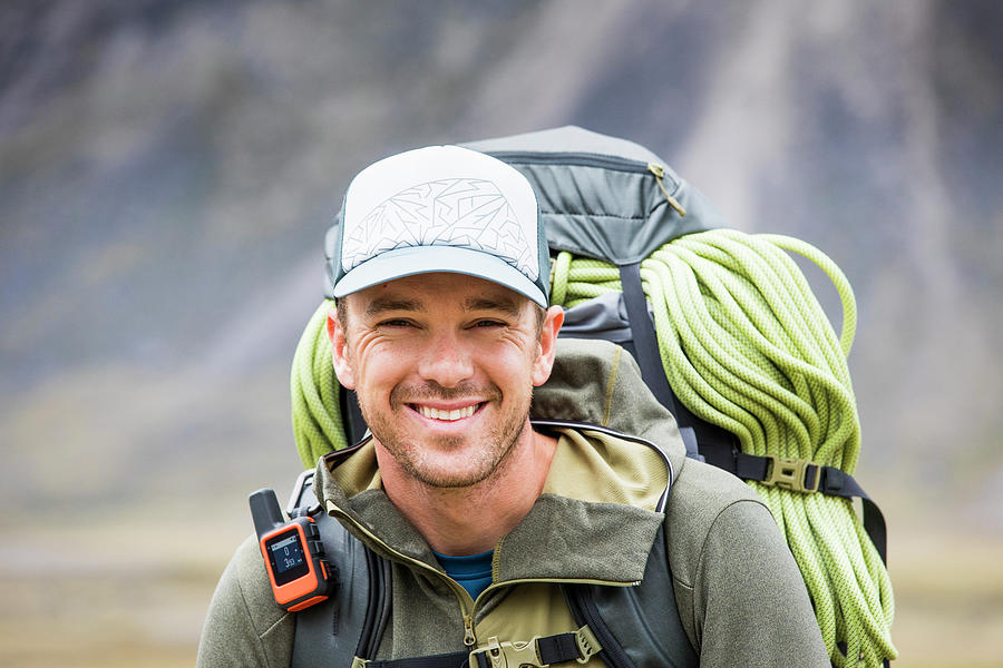 Portrait Of Climber Wearing Backpack, Rope And Gps Communication Tool ...