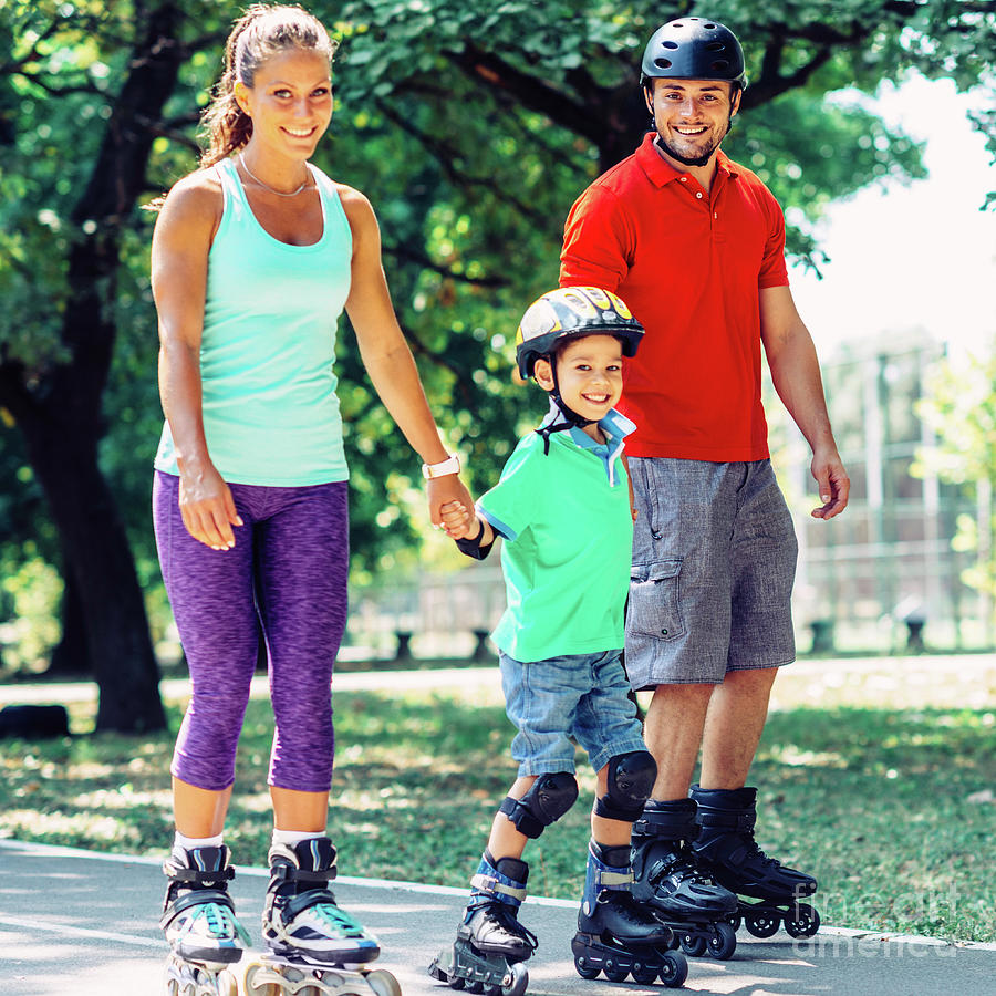 Portrait Of Family On Roller Skates In Park Photograph by Microgen Images/science Photo Library