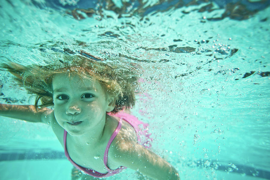 Portrait Of Girl Swimming Underwater In Pool Photograph by Cavan Images ...