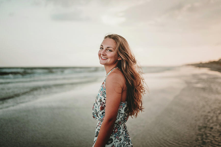 Sunset Photograph - Portrait Of Happy Woman Standing At Beach Against Sky During Sunset by Cavan Images