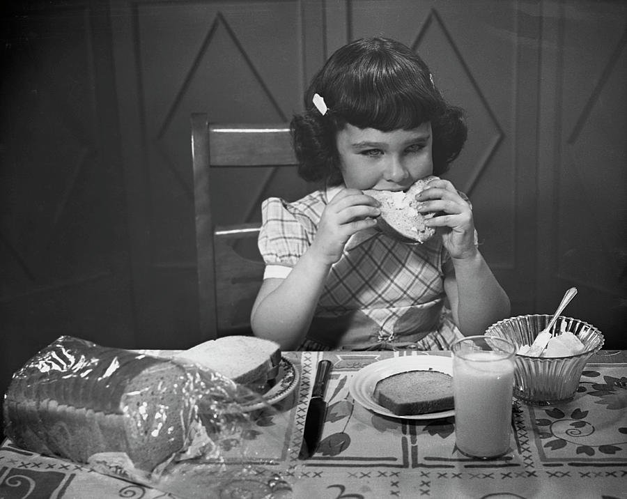 Portrait Of Little Girl Eating Buttered Photograph by George Marks