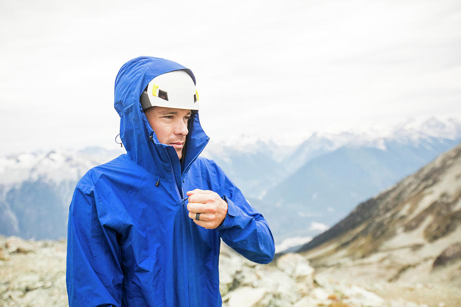 Portrait Of Mountain Climber Zipping Up Rain Jacket. Photograph by ...