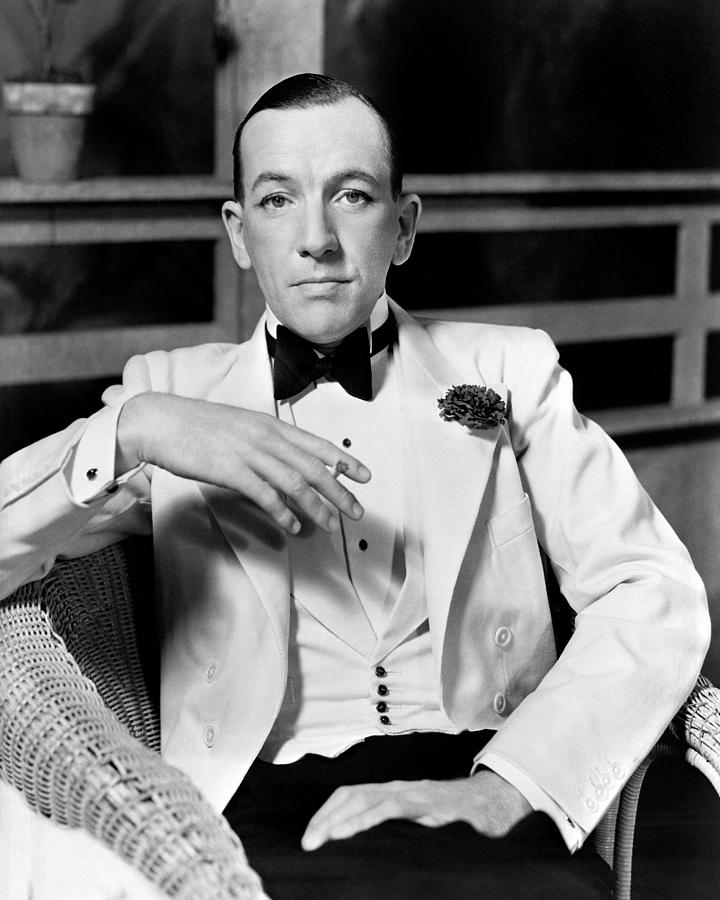 Portrait Of Noel Coward Sitting On Chair Photograph by Globe Photos ...