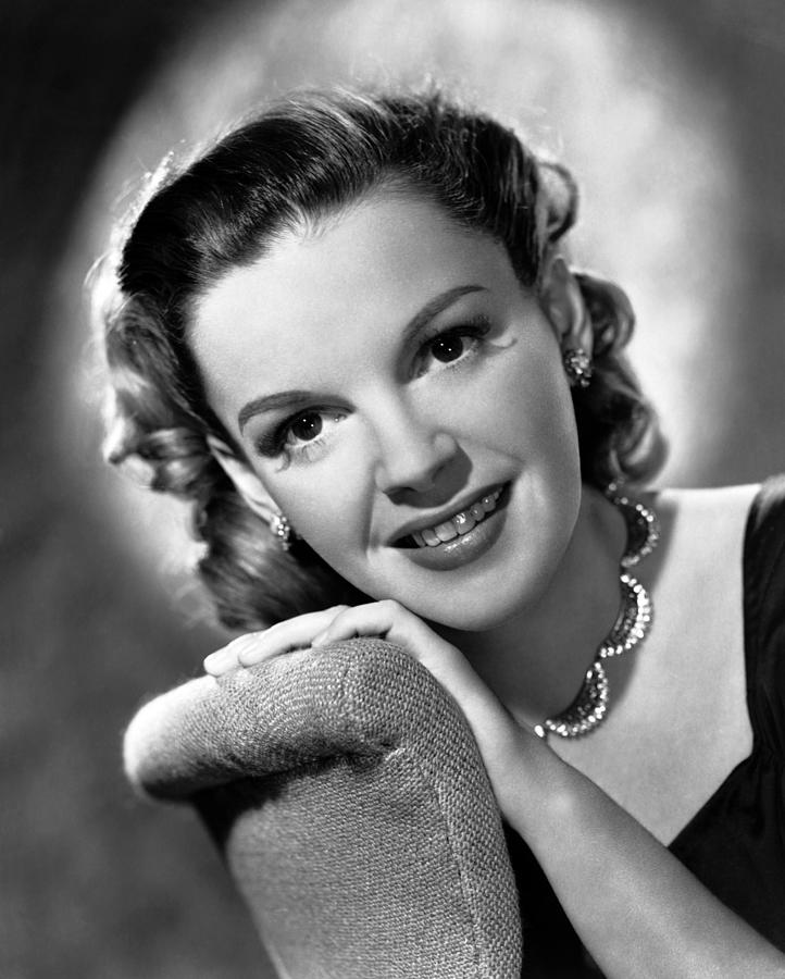 Portrait Of Smiling Judy Garland Leaning On Couch Photograph by Globe ...