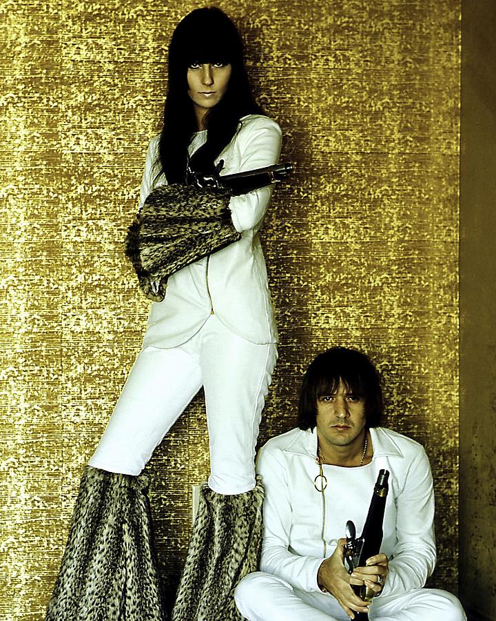 Cher Photograph - Portrait Of Sonny Bono And Cher Posing With Guns During Publicity Shoot by Globe Photos
