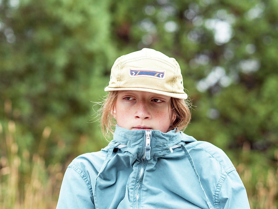 Nature Photograph - Portrait Of Teen Boy Looking Off Frame With Hat And Wind Breaker by Cavan Images