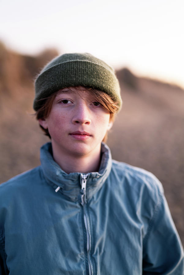 Portrait Of Teenage Boy Wearing Beenie Standing On Beach Photograph by ...