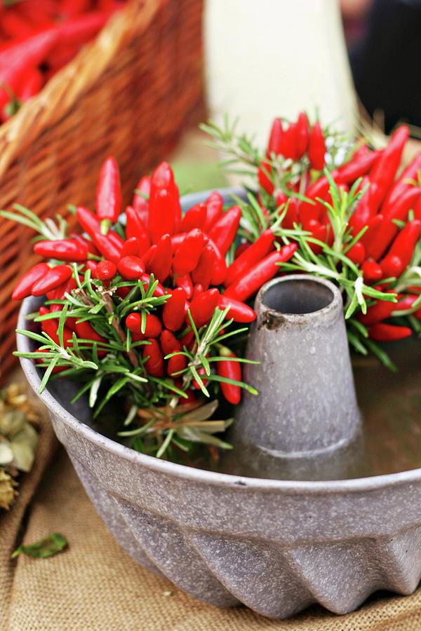 Posies Of Chilli Peppers & Rosemary In Cake Mould Photograph by Alexandra Panella