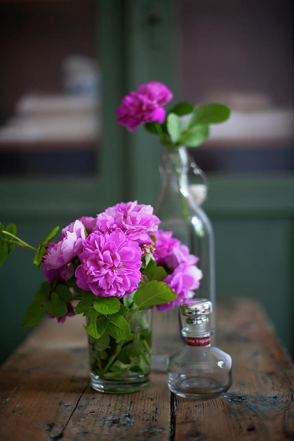 Posy Of Pink Roses In Glass Of Water On Wooden Table Photograph by Alicja Koll
