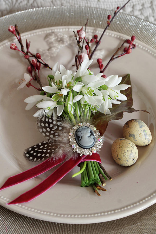 Posy Of Snowdrops, Sprigs Of Purple-leafplumtree Blossom, Feathers And Ivy Leaf Decorating Plate For Easter Meal Photograph by Angelica Linnhoff