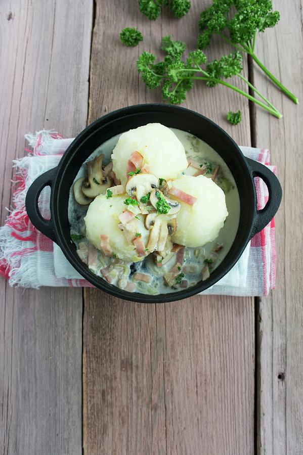 Potato Dumplings With A Mushroom And Bacon Sauce Photograph by Martina Schindler