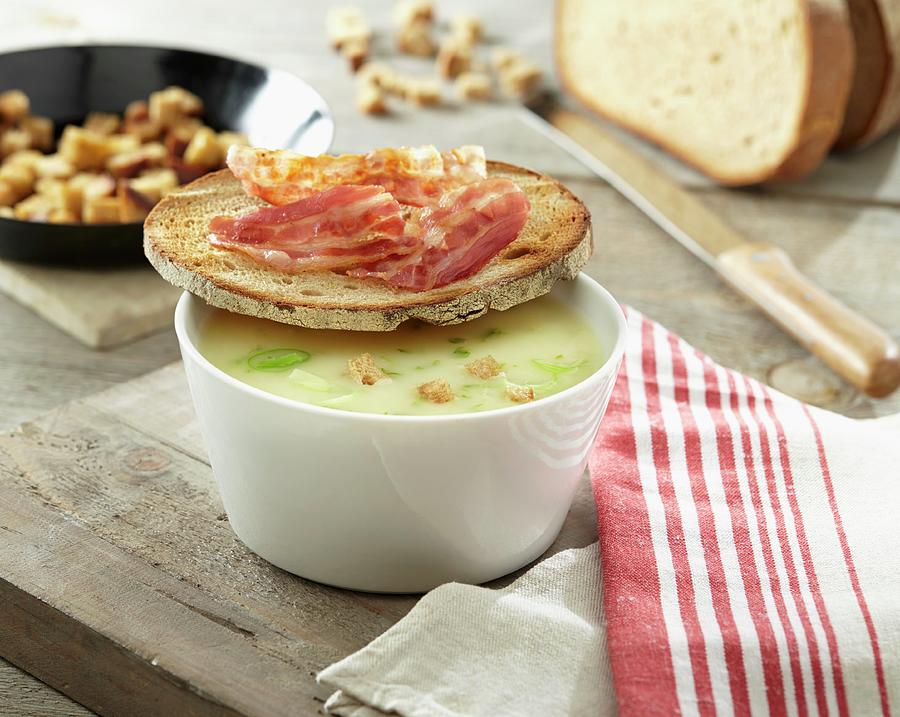 Potato Soup With Croutons And A Slice Of Bread Topped With Bacon Photograph by Christopher Mick