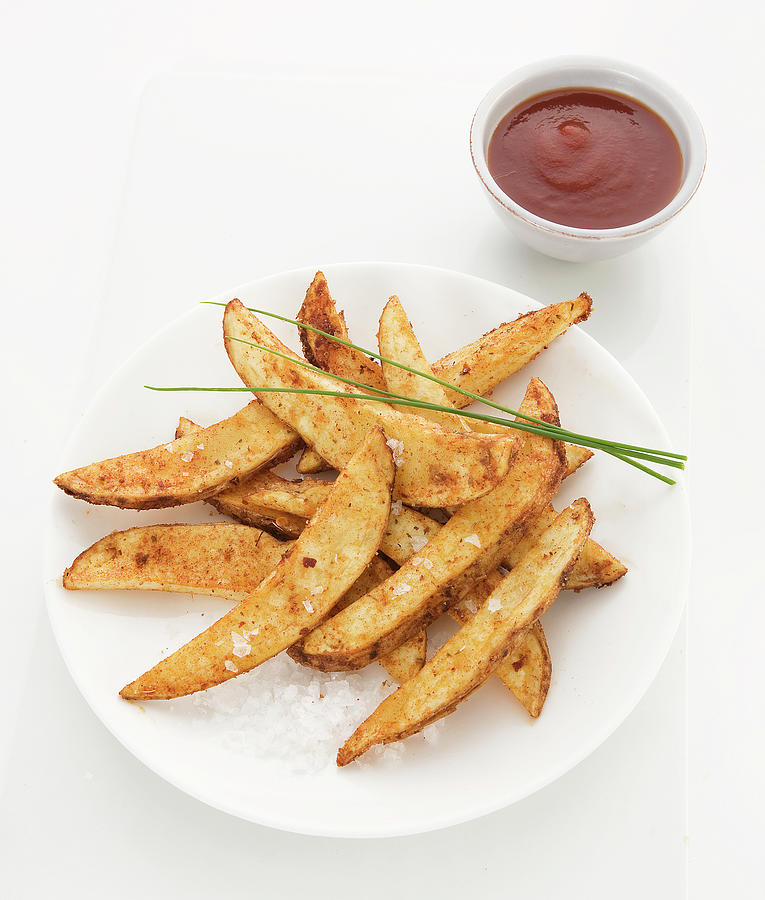 Potato Wedges Backed With Paprika, Sprinkled With Sea Salt And Chives, Tomato Sauce On Side Photograph by Trudy Kelder