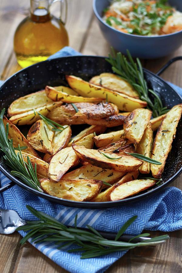Potato Wedges With Rosemary Photograph by Helena Krol