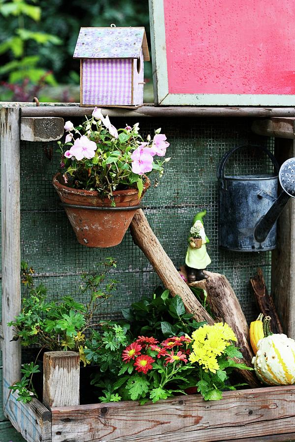 Potting Table Decorated With Flowers, Watering Can & Nesting Box Photograph by Alexandra Panella