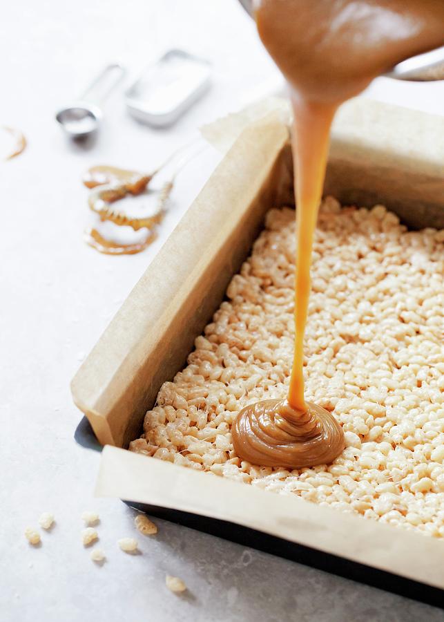 Pouring Caramel Over Rice Krispie Marshmallow Treat Base Photograph by Jane Saunders