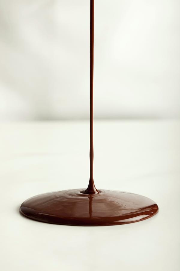 Pouring Chocolate Onto A Flat Surface Photograph by Medina